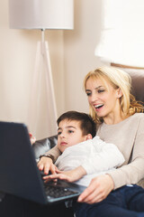 Mother and her child using laptop pc