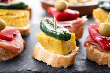 Traditional Spanish pintxos on wooden table