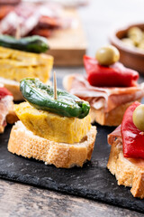 Traditional Spanish pintxos on wooden table