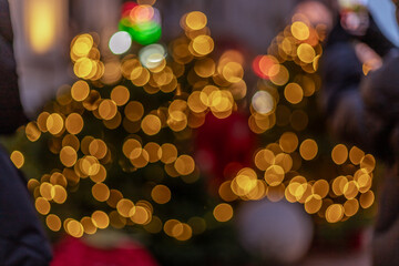 Warm bokeh lights blur elegantly against a soft, out-of-focus background, with hints of dark colors framing the luminous golden orbs, creating a dreamy, festive atmosphere
