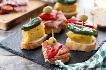 Traditional Spanish pintxos on wooden table