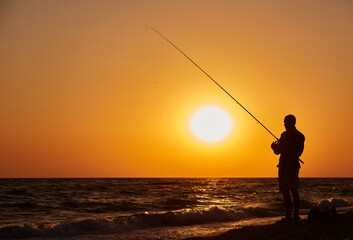 Silhouette of Fisherman at Sunset