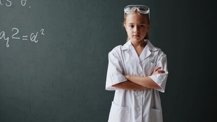 Confident young scientist posing with crossed arms in front of a blackboard with a mathematical formula, showcasing intelligence and passion for science