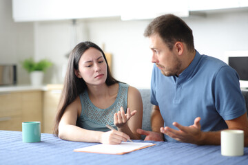 Angry woman asking for explanation to her confused partner