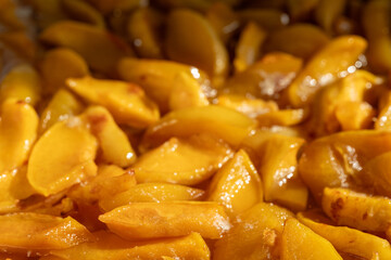 Golden slices of baked apples in a warm dish ready for dessert at a cozy kitchen setting