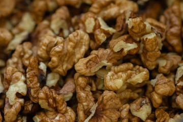 Walnuts in a close-up view highlighting their rich texture and natural color in a wooden bowl