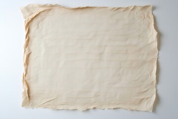 Obraz premium Wrinkled beige textured paper with visible fibers resembling handmade paper is lying on a white background, providing copy space
