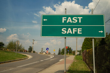 tablica przy drodze z kierunkami w lewo i prawo oraz napisami: FAST oraz SAFE