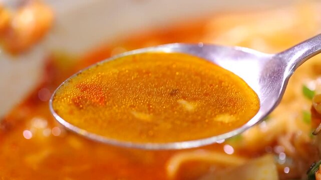 Spoonful of spicy seafood noodle soup
