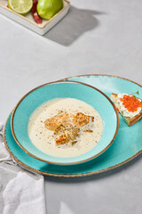 Creamy Fish Soup in Rustic Blue Bowl with Elegant Modern Presentation