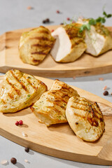 Grilled turkey medallions on rustic wood board, natural lighting, vibrant color palette