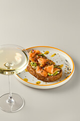 Elegant Salmon and Avocado Bruschetta with Wine in Modern Minimalist Composition