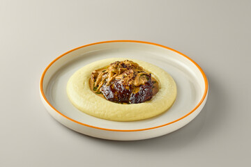 Gourmet Plated Dish with Creamy Potato Puree and Savory Mushroom Sauce
