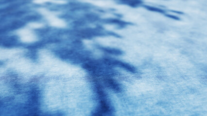 Obraz premium Soft shadows dancing on a blue tie dye fabric, creating a mesmerizing texture