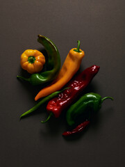 Different peppers over brown background