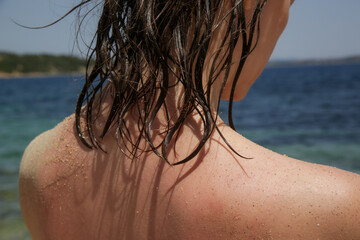 Woman's hair on the beach. Wet hair close up image. Hair damage due to salty ocean water and sun,...