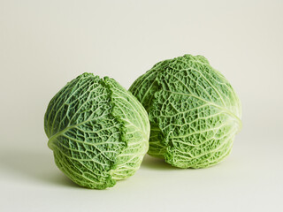 Savoy cabbage over beige background