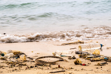 Plastic waste, plastic cups at the beach. Concept of environmental problems and saving the plane	
