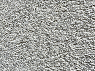 Close-up of textured white concrete wall surface pattern
