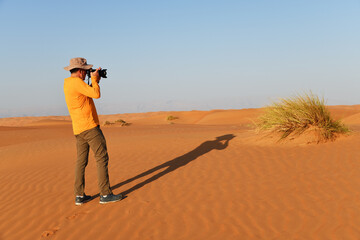 Tourist in Dunes of Rub Al Khali desert. Wahiba Sands. Sultanate of Oman.