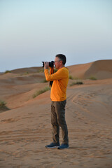 Tourist in Dunes of Rub Al Khali desert. Wahiba Sands. Sultanate of Oman.