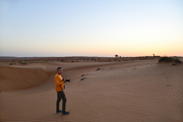 Tourist in Dunes of Rub Al Khali desert. Wahiba Sands. Sultanate of Oman.
