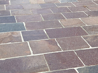 Close-up of varied color stone brick pavement with irregular patterns
