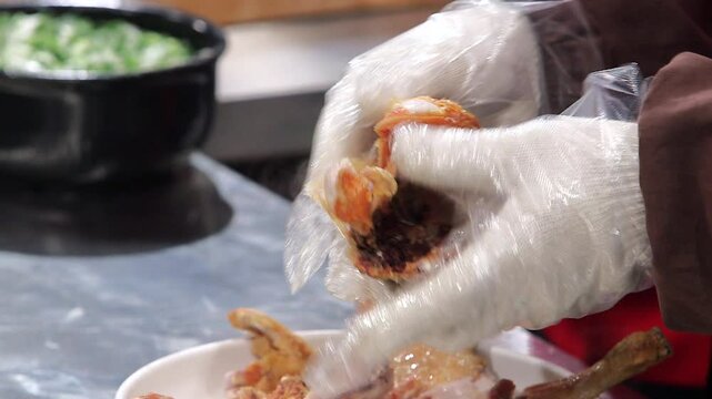 Ripping fried chicken with one's hands