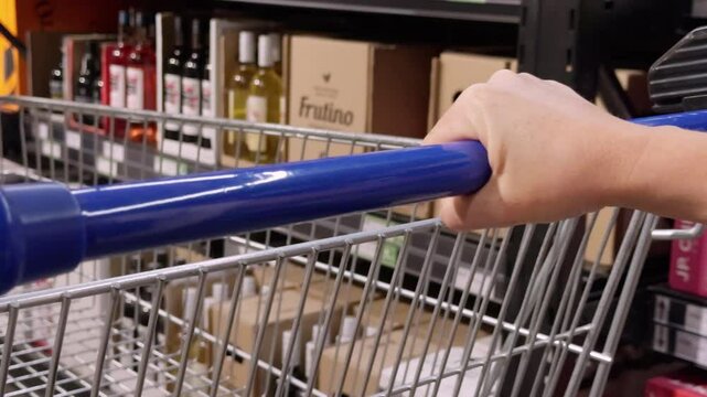 Woman shopping groceries, retail environment supermarket, food products store shelves, healthy lifestyle shopping, supermarket customer behavior, blurry shopping cart movement.