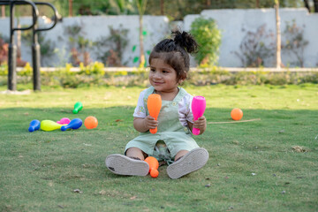 Little kid playing in garden area or park