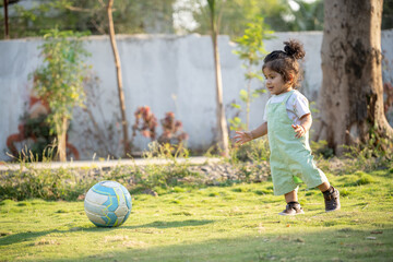 Little kid playing in garden area or park