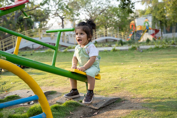 Little kid playing in garden area or park