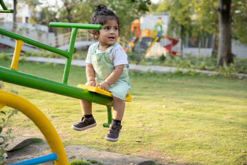 Little kid playing in garden area or park
