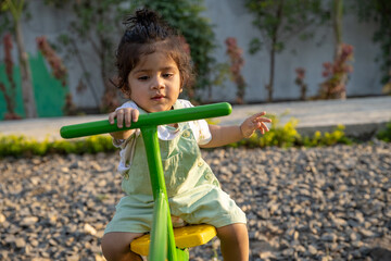 Little kid playing in garden area or park