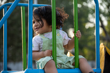 Obraz premium Little kid playing in garden area or park