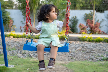 Little kid playing in garden area or park