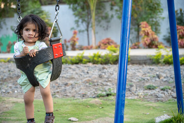 Little kid playing in garden area or park