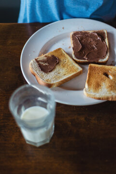 boy eating breakfast, spreading toast