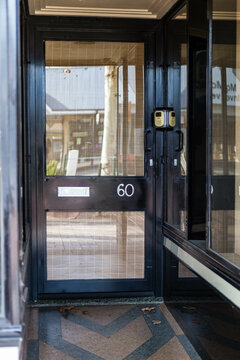 Black door with glass with number 60