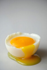 egg yolk in a bowl on a white surface