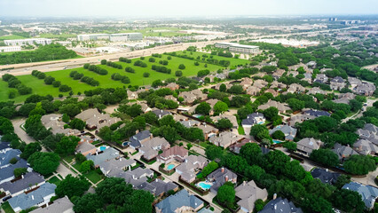 Vacant land with trees along Dallas North Tollway in rapid growing mixed use development area of business park campus buildings, upscale residential neighborhood home along West Plano Parkway