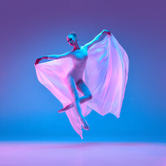 Dynamic photo of ballerina dancing midair holding wide-stretched veil under neon lights symbolizing human connection to freedom and expression. Concept of beauty, ballet, dance, movement. © Lustre Art Group 