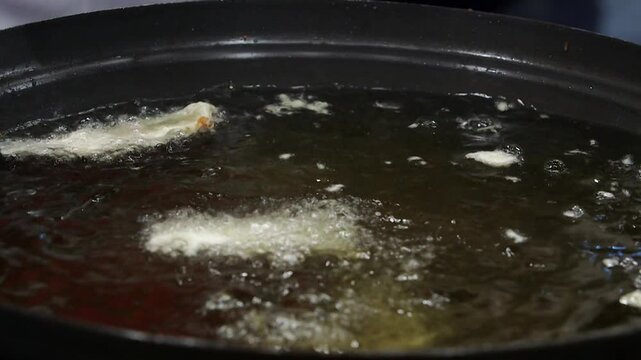 Sweetfish coated in batter and fried in hot oil