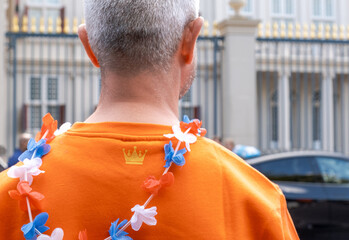 man back orange sweater garland Dutch flag birthday King Netherlands