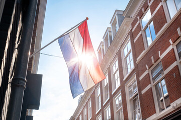 Flag Netherlands blue sky old city Holland building Den Haag Koningsdag orange