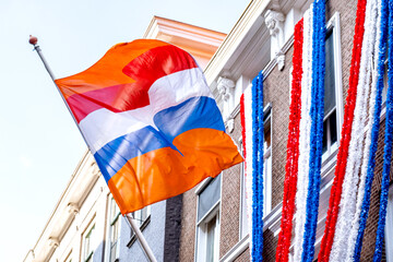 Flag Netherlands blue sky old city Holland building Den Haag Koningsdag orange