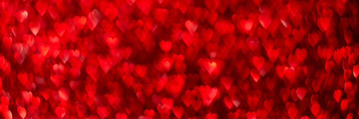 Red hearts, sparkling glitter bokeh background banner, valentines day abstract defocused texture header.