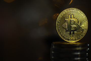 Golden Bitcoin Coin on Stack with Dark Background Symbolizing Cryptocurrency Investment and...