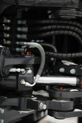 Close-Up of Industrial Hydraulics and Mechanical Components with Coiled Hoses and Bolts
