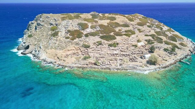 Aerial shot of Mochlos ancient minoan city on Crete, surrounded by turquoise waters